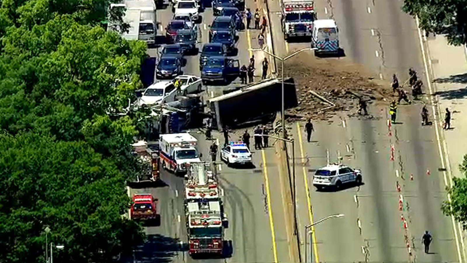 Dump truck overturns on Long Island Expressway in Queens, causing ...