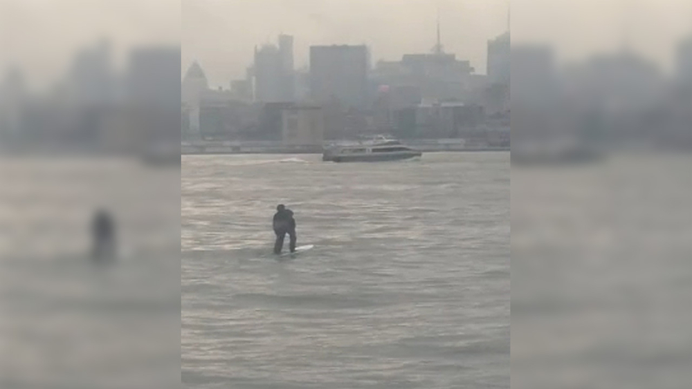 Man paddle boards across Hudson River - and makes it to work on time!