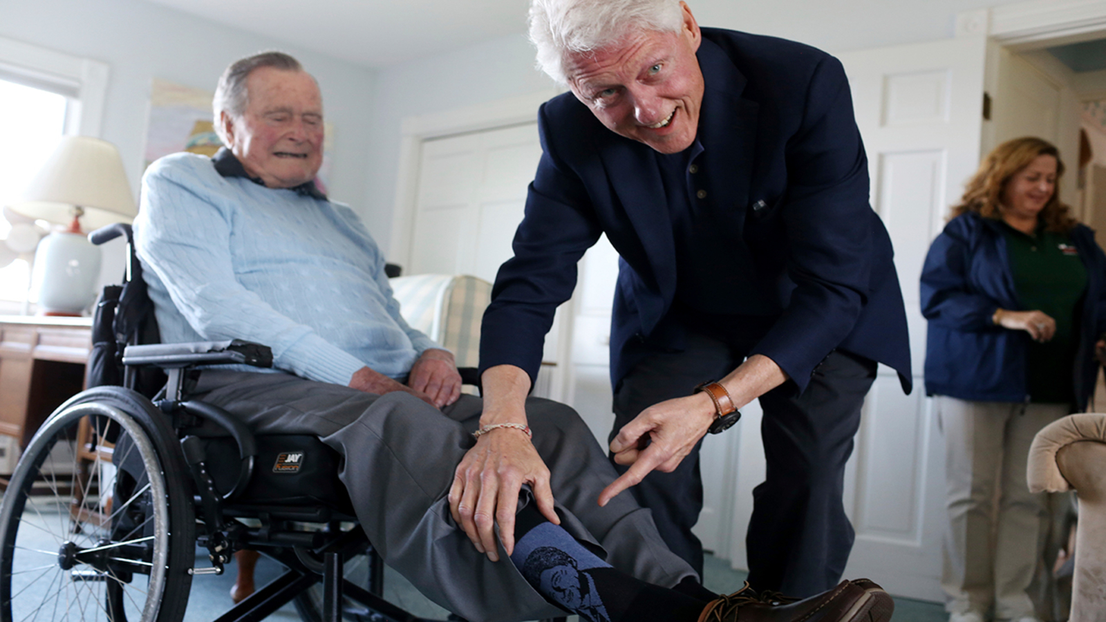 Former presidents H.W. Bush and Bill Clinton share a moment in