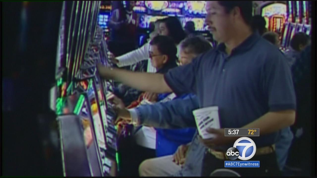 A group of people play slots in this undated file photo.