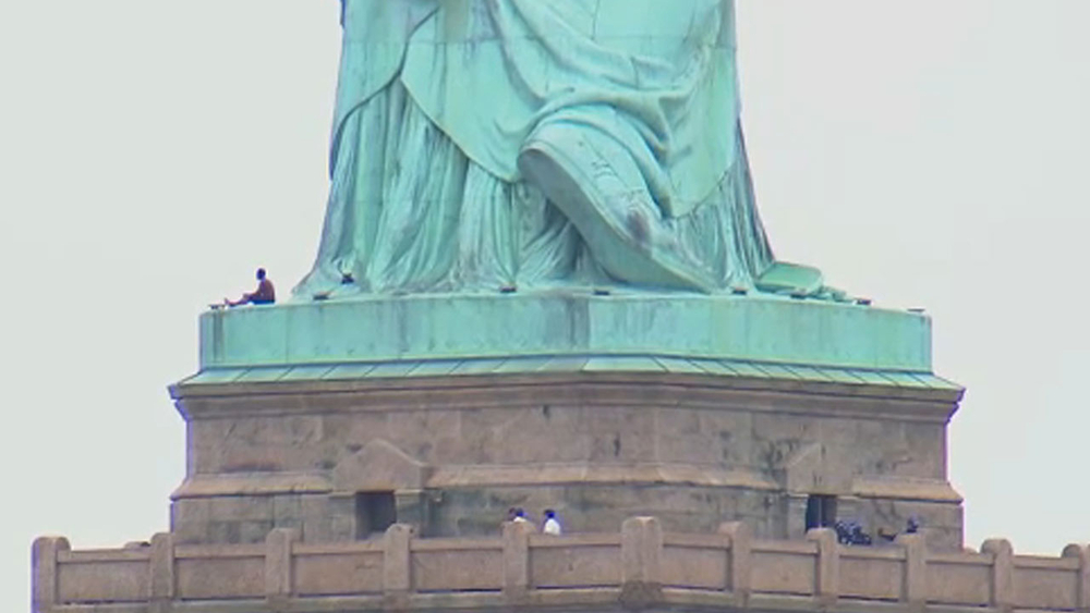 Woman climbs Statue of Liberty; Liberty Island evacuated