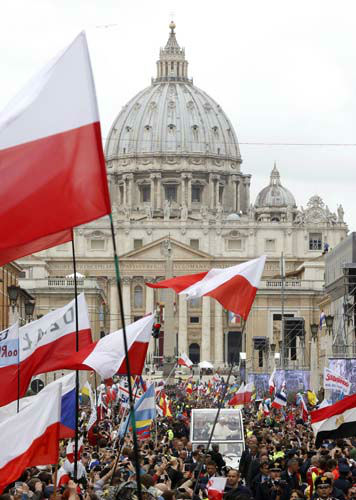 Pope Francis greets faithful as he is driven through the crowd along Via della Conciliazione after celebrating the ceremony for the canonizations of Pope John XXIII and Pope John Paul II in St. Peter's Square, at the Vatican, Sunday, April 27, 2014. Pope Francis declared his two predecessors John XXIII and John Paul II saints before some 800,000 people on Sunday, an unprecedented ceremony made even more historic by the presence in St. Peter's Square of emeritus Pope Benedict XVI. (AP Photo/Riccardo De Luca)