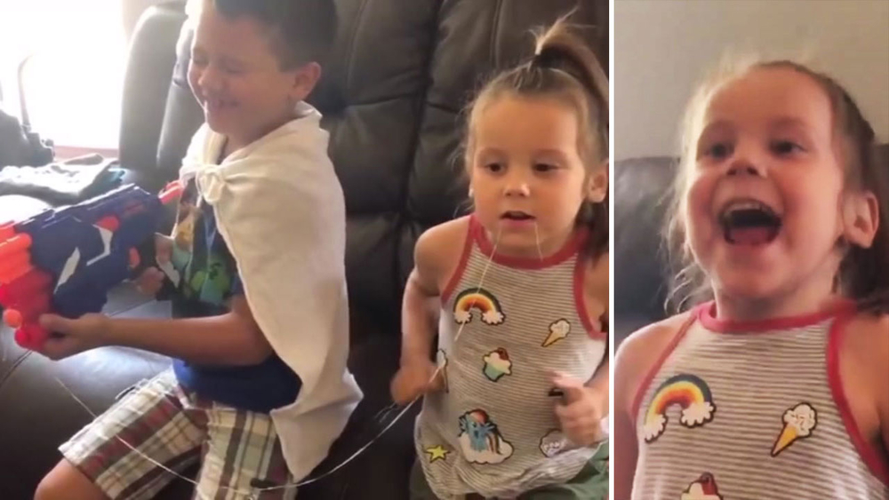 Boy with Nerf gun helps little sister pull loose tooth