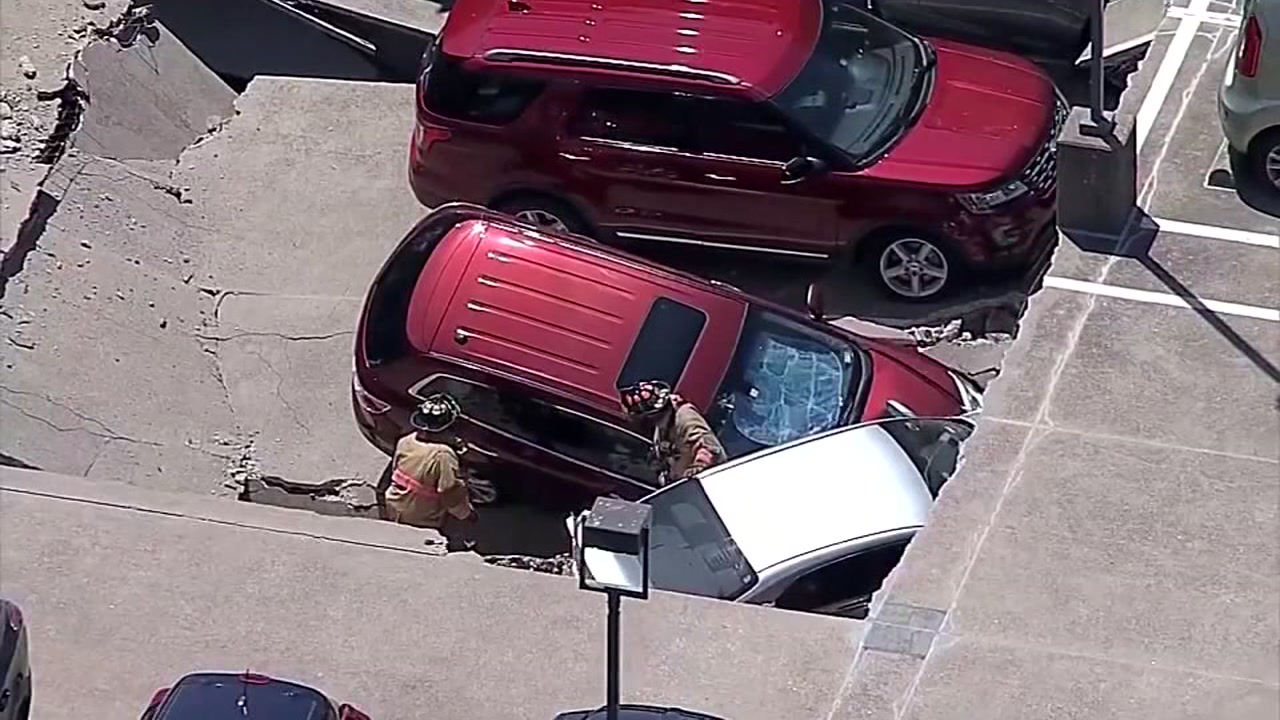 Vehicles crash down onto other vehicles after parking garage collapse
