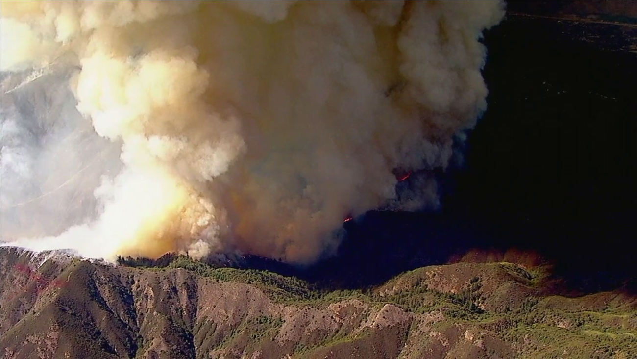 A plume of smoke goes up in the air as brush burns in the Holy Fire in the Trabuco Canyon area on Monday, Aug. 6, 2018.