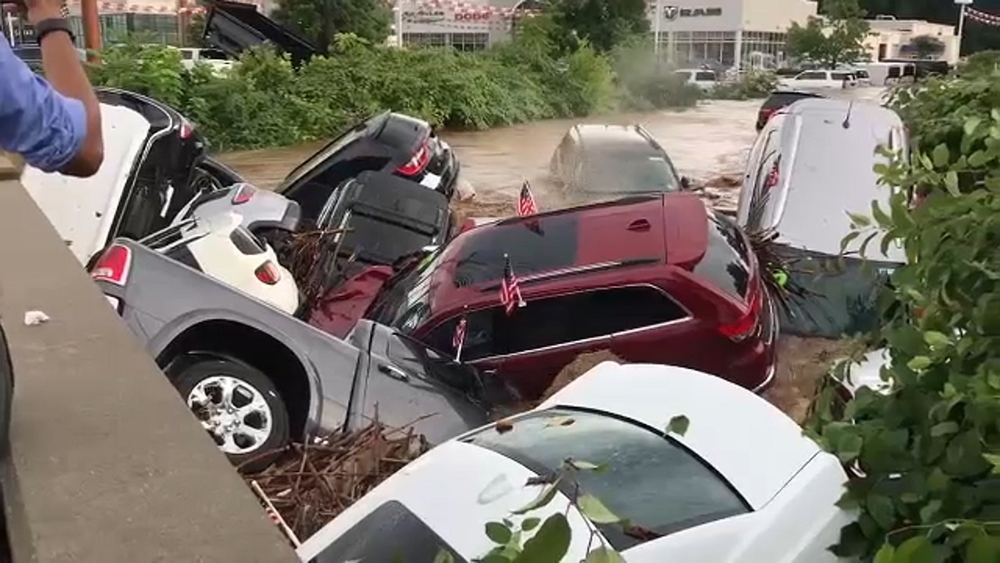 Cars float away in flood waters in Little Falls, New Jersey