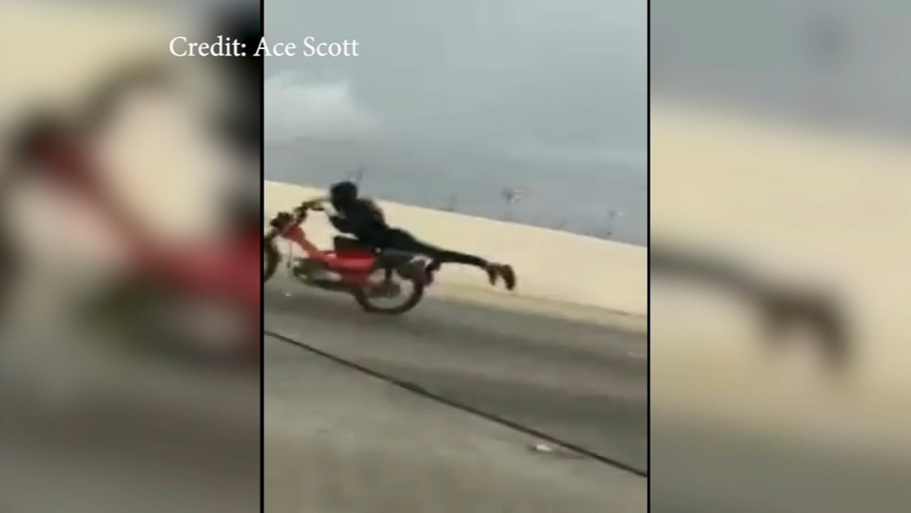 Daredevil motorcyclist performs stunt