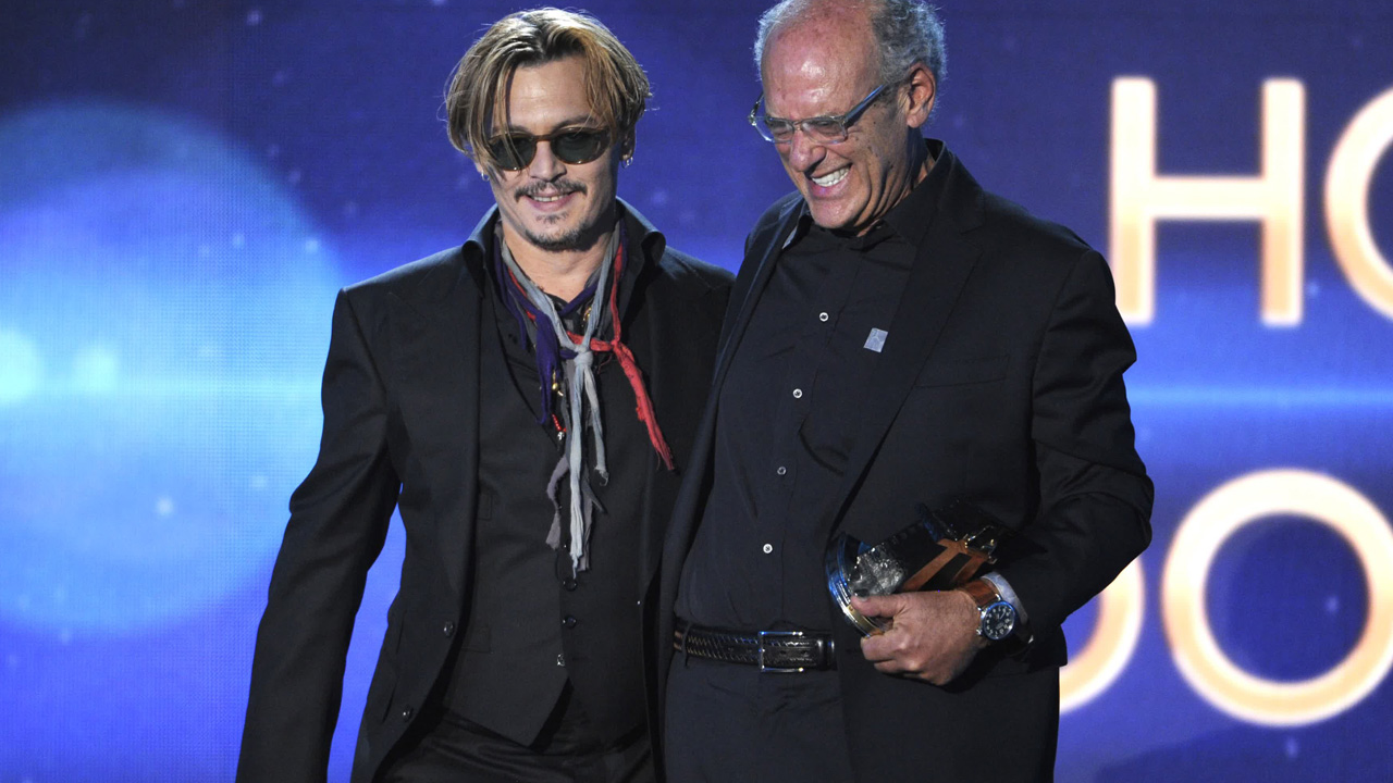Johnny Depp, left, presents the Hollywood documentary award to Shep Gordon at the Hollywood Film Awards at the Palladium on Friday, Nov. 14, 2014, in Los Angeles.