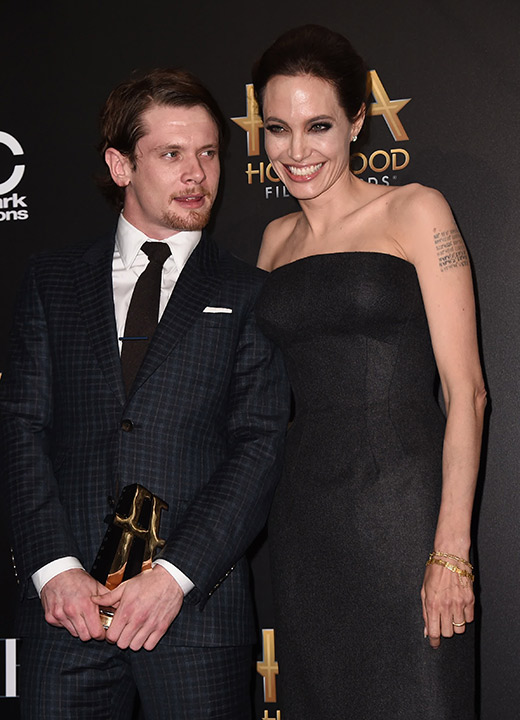 Jack O'Donnell, winner of the new Hollywood award, left, and Angelina Jolie pose in the press room at the Hollywood Film Awards at the Palladium on Friday, Nov. 14, 2014, in L.A.