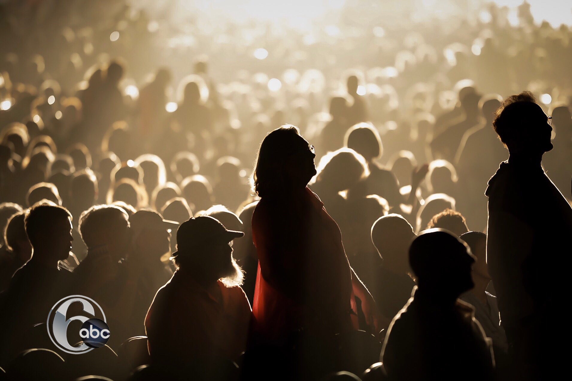 Fans enjoying the Outlaw Music Festival as the sun sets.