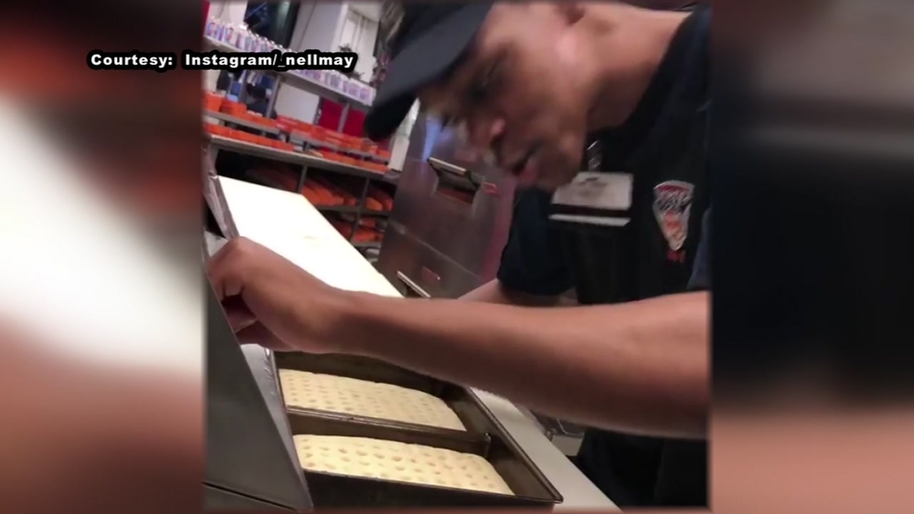 Stadium worker fired after he's recorded spitting on pizza