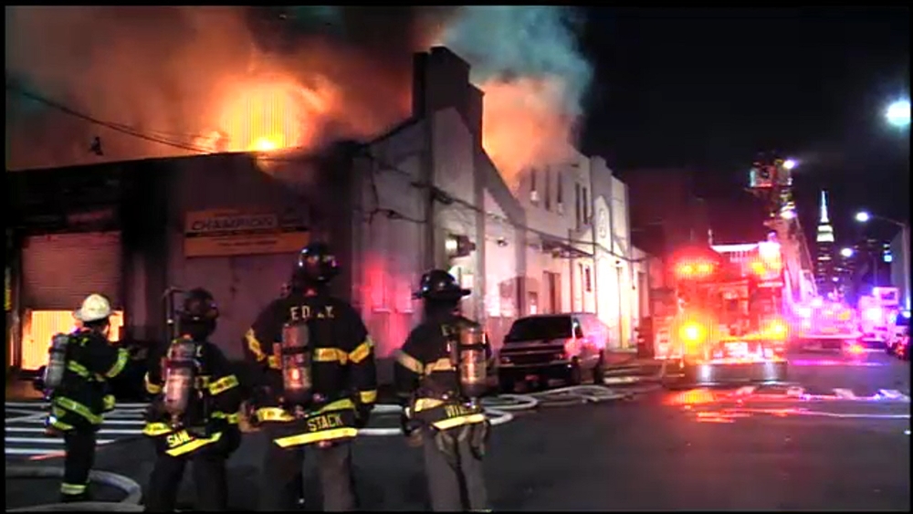 Fire rages at Queens auto body shop