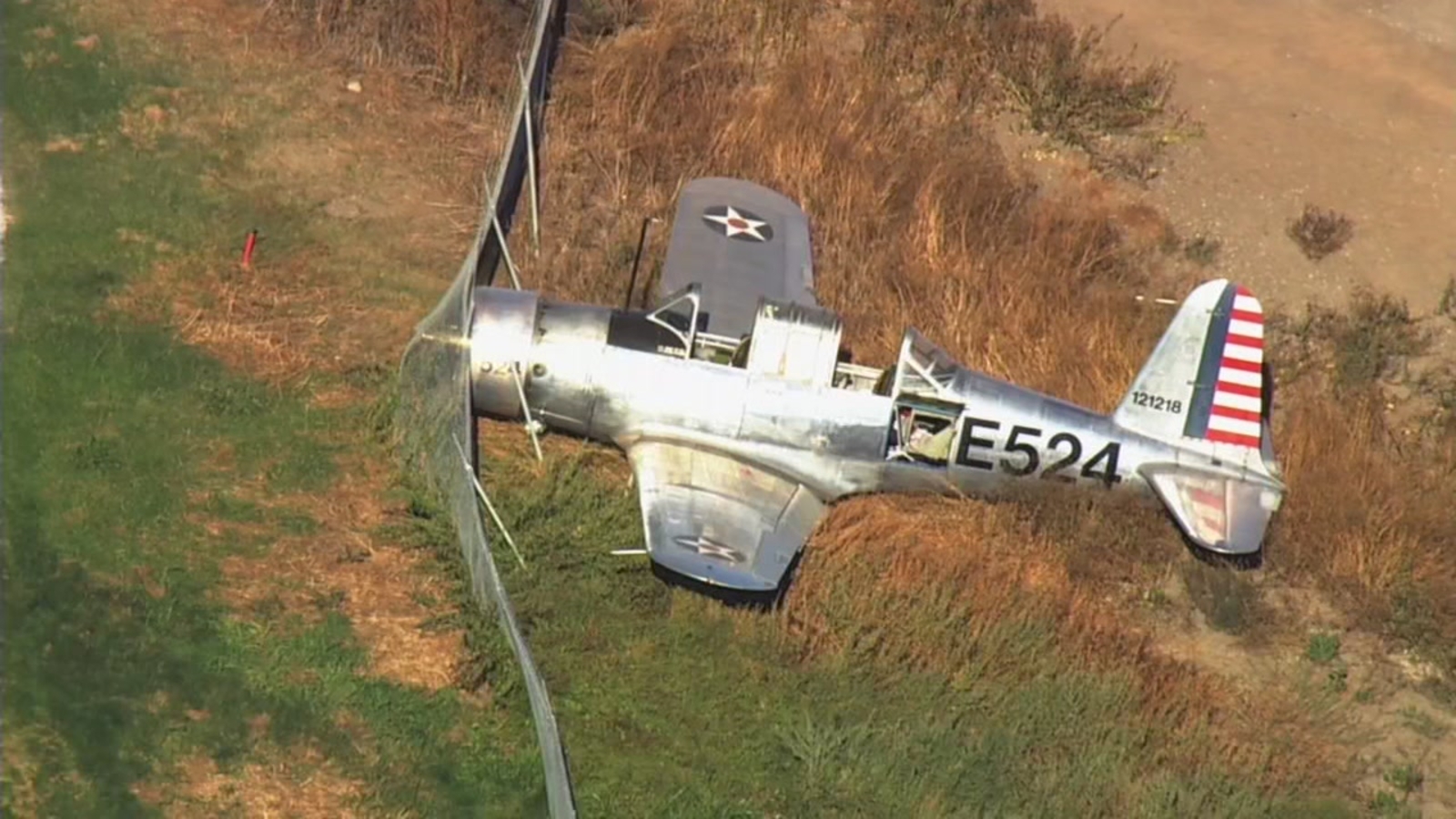 Pilot reportedly walks away after WWII era plane crashes into golf Pilot reportedly walks away after WWII era plane crashes into golf