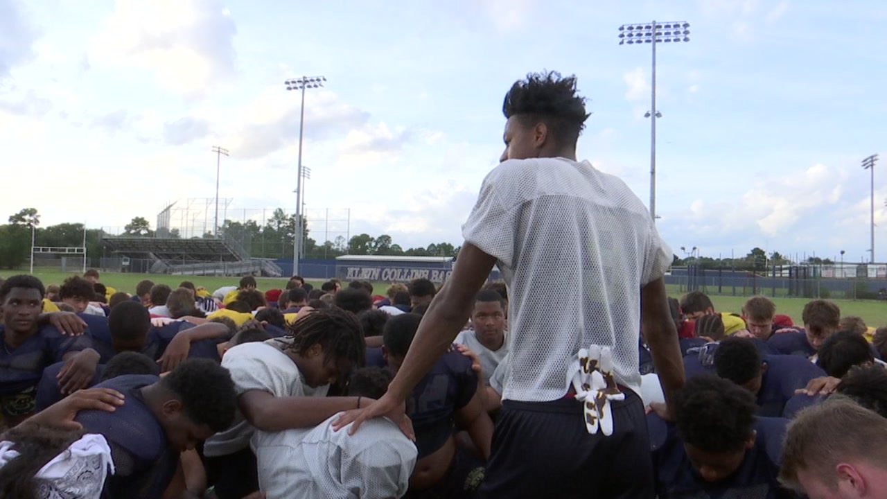 COMING TOGETHER: Rivals huddle in prayer after player injured