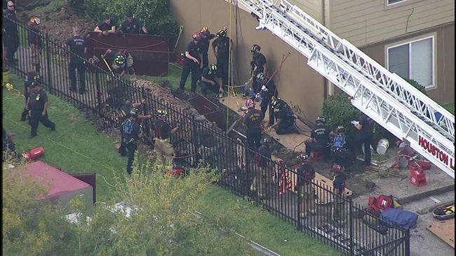 Worker rescued after getting trapped in trench collapse beneath ...