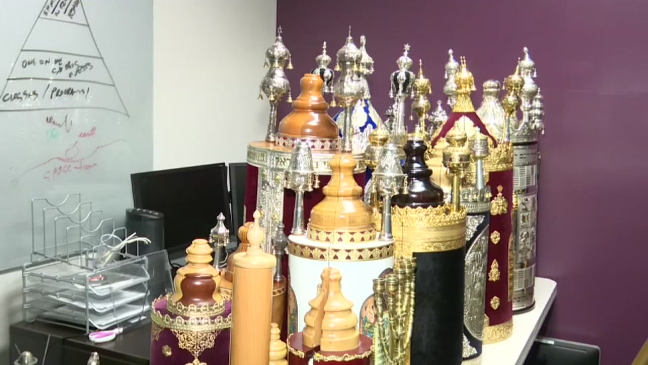 Firefighters save sacred Torah scrolls from fire.