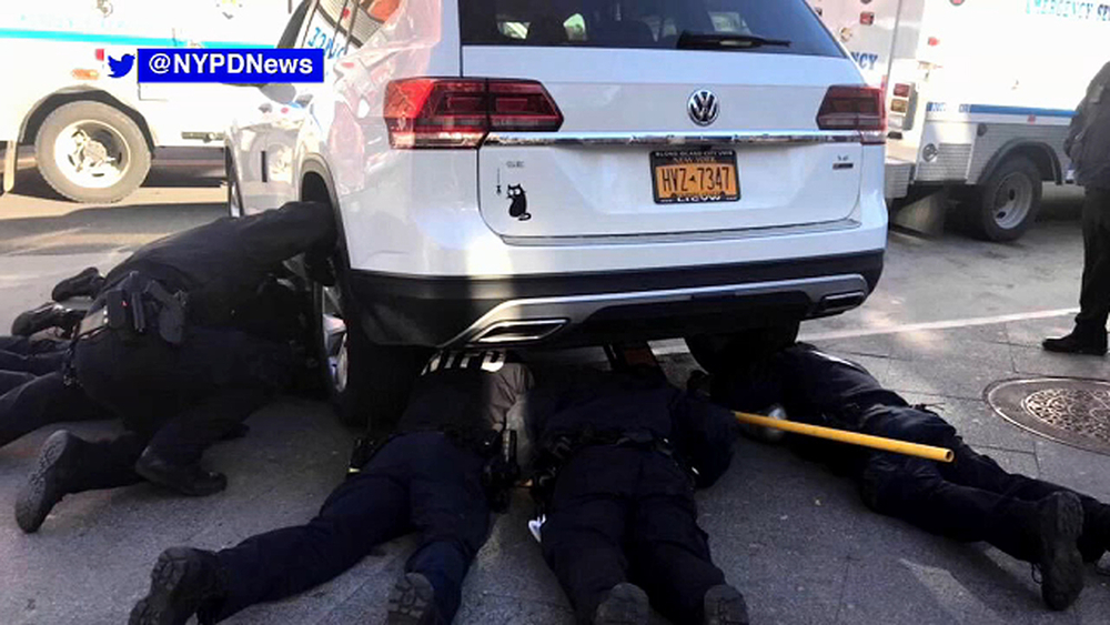 NYPD officers rescue kitten stuck in engine of SUV