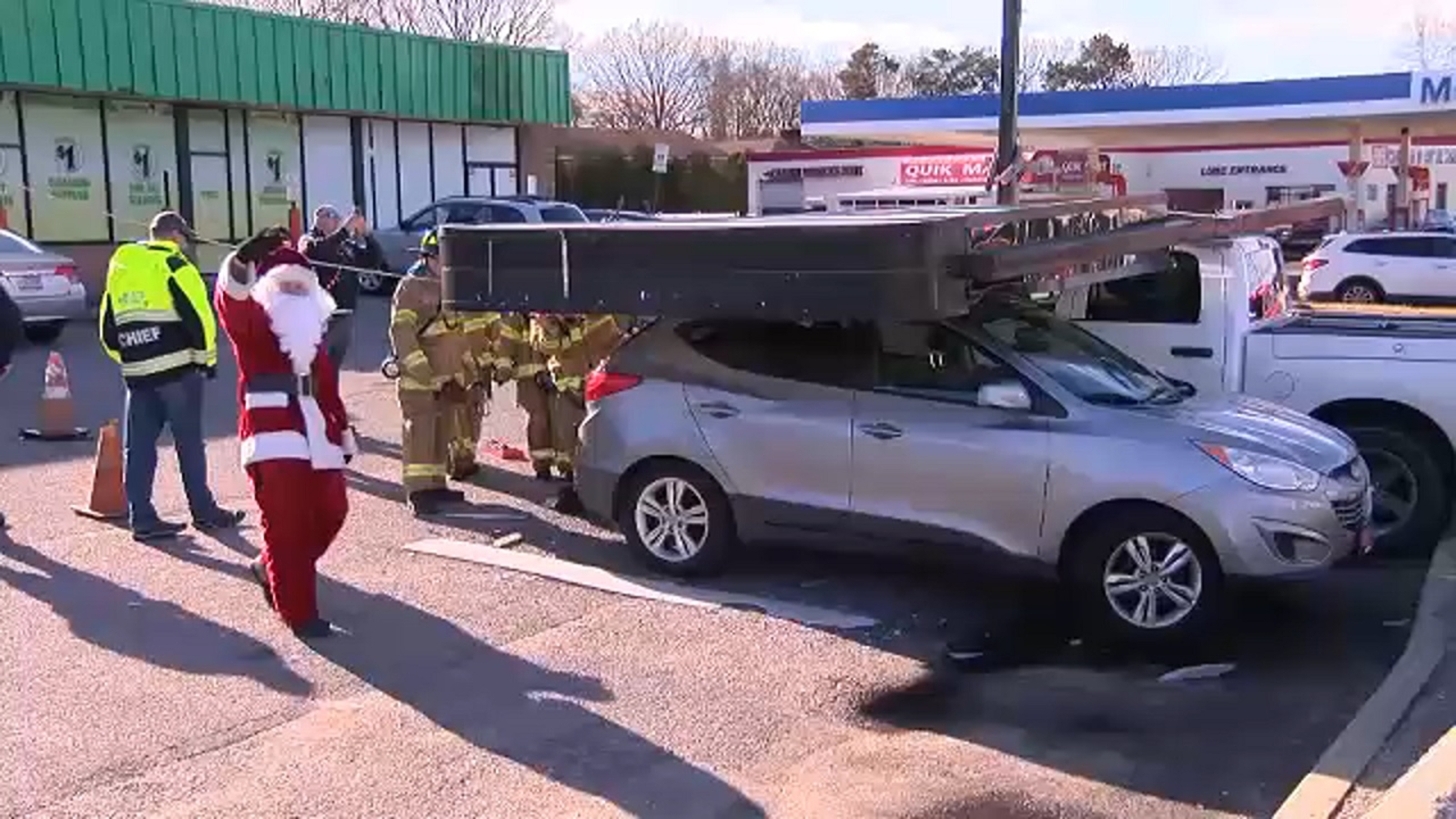 Santa, firefighters respond to parking lot in Sayville after sign falls