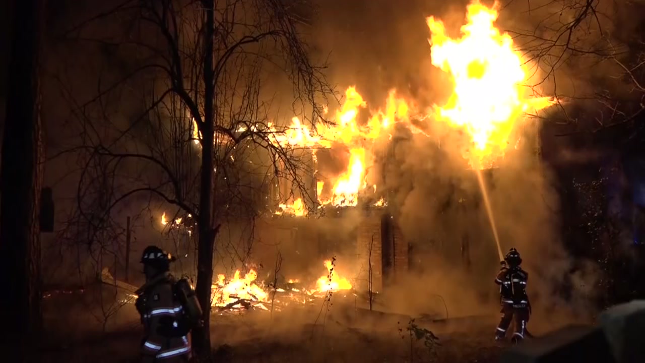 Firefighters battle heavy flames as fire threatens business