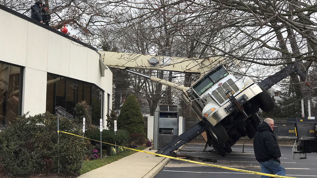 Crane topples onto office building on Long Island