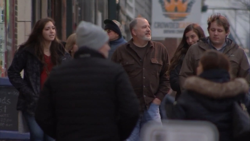 Folks try to stay warm as light snow falls in Phoenixville