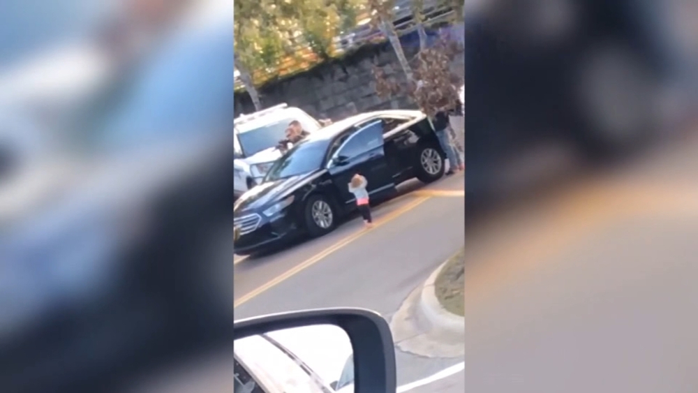 Toddler walks toward police with hands up as dad gets arrested