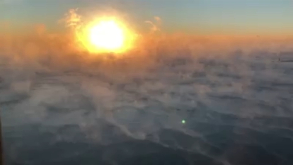 Steamy sunrise over frozen Lake Michigan