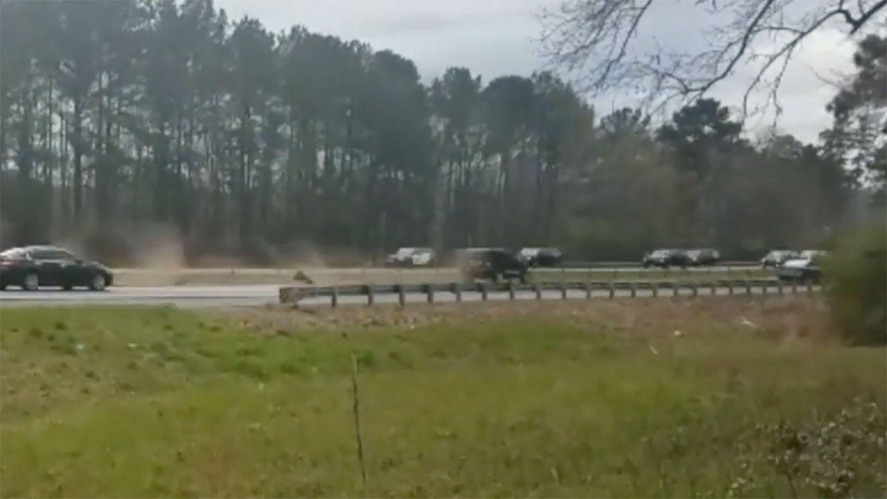 Car crashes into highway median as Trump motorcade passes