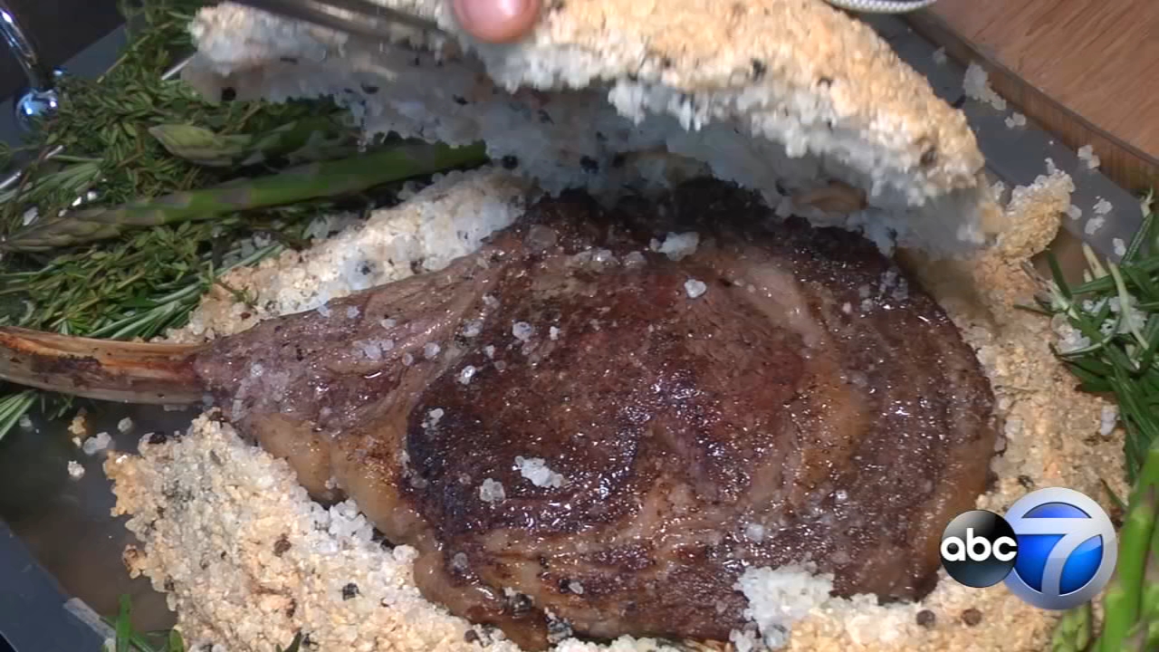 Tomahawk steak baked in mountain of salt at River North's Travelle