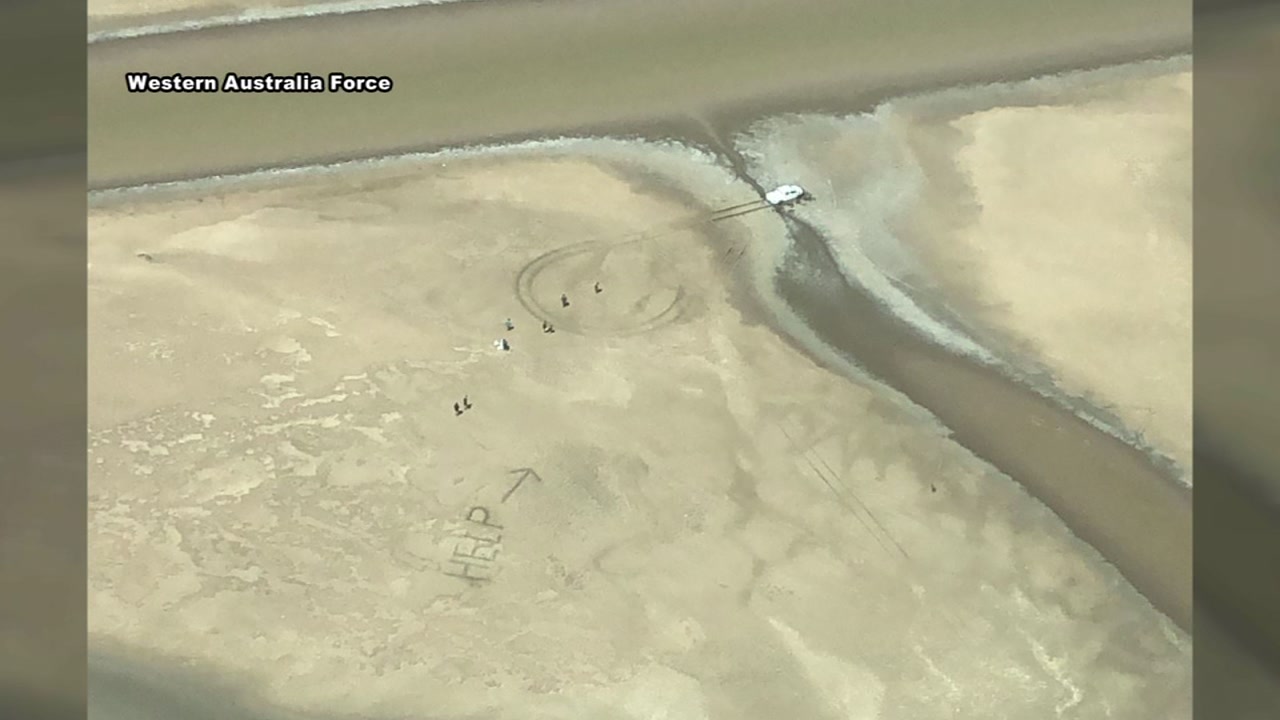 Couple stuck in crocodile swamp write 'Help' in mud