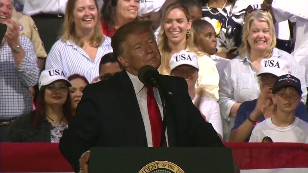 During a campaign rally in Panama City Beach, Florida, President Donald Trump joked after someone made a comment that migrants coming into the United States should be shot.