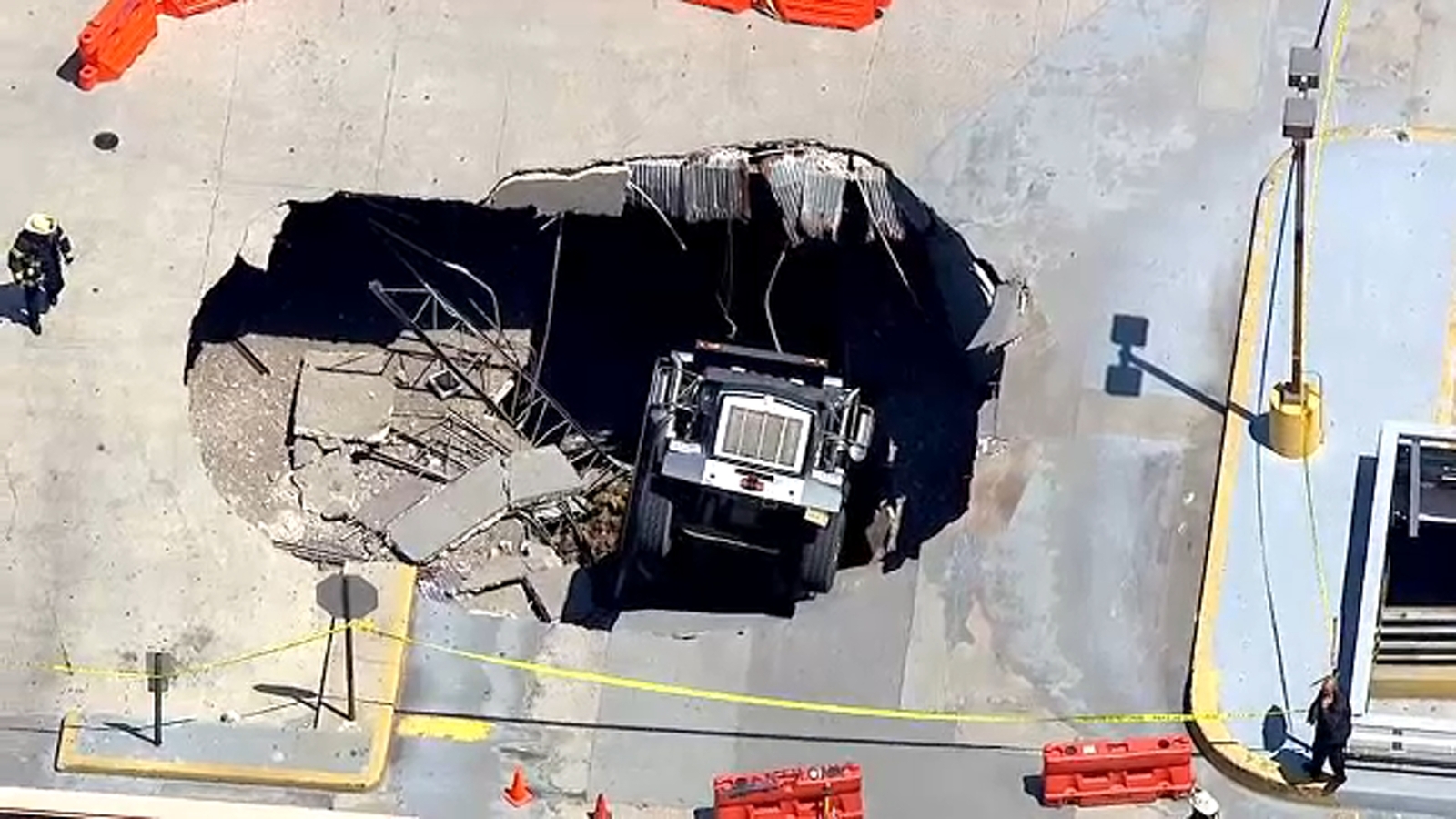 Dump truck falls through upper level of parking garage in North Bergen