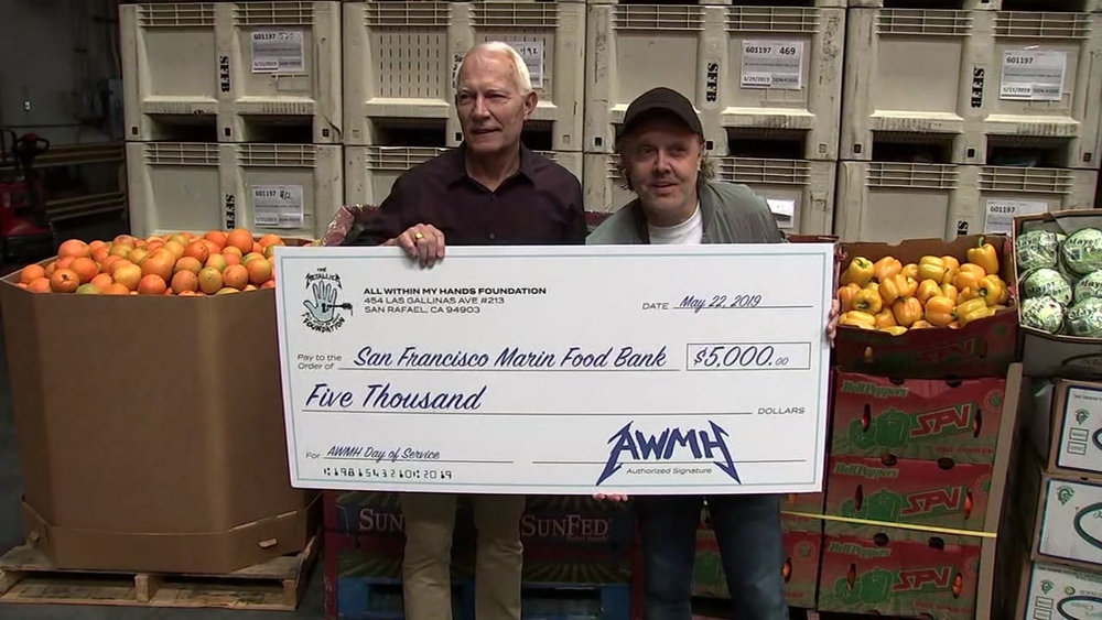 Metallica's drummer presents check at SF-Marin Food Bank
