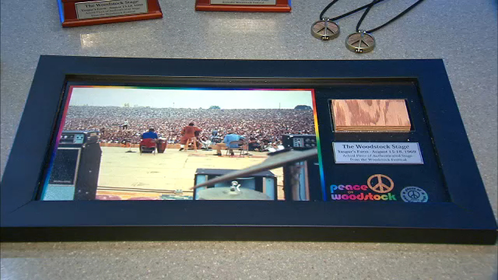 Man selling pieces of the original stage from Woodstock