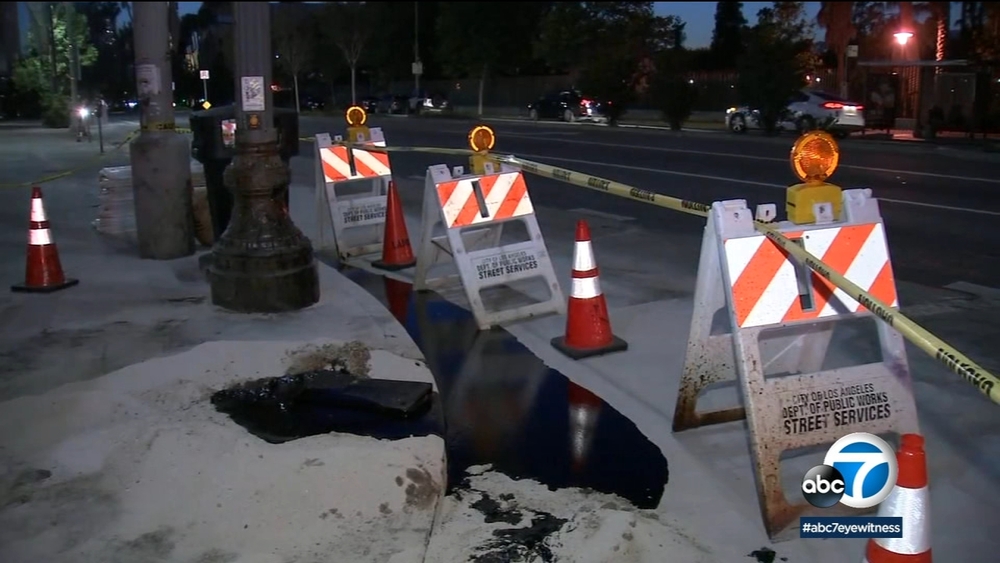 Tar oozes on to sidewalk, street near La Brea Tar Pits