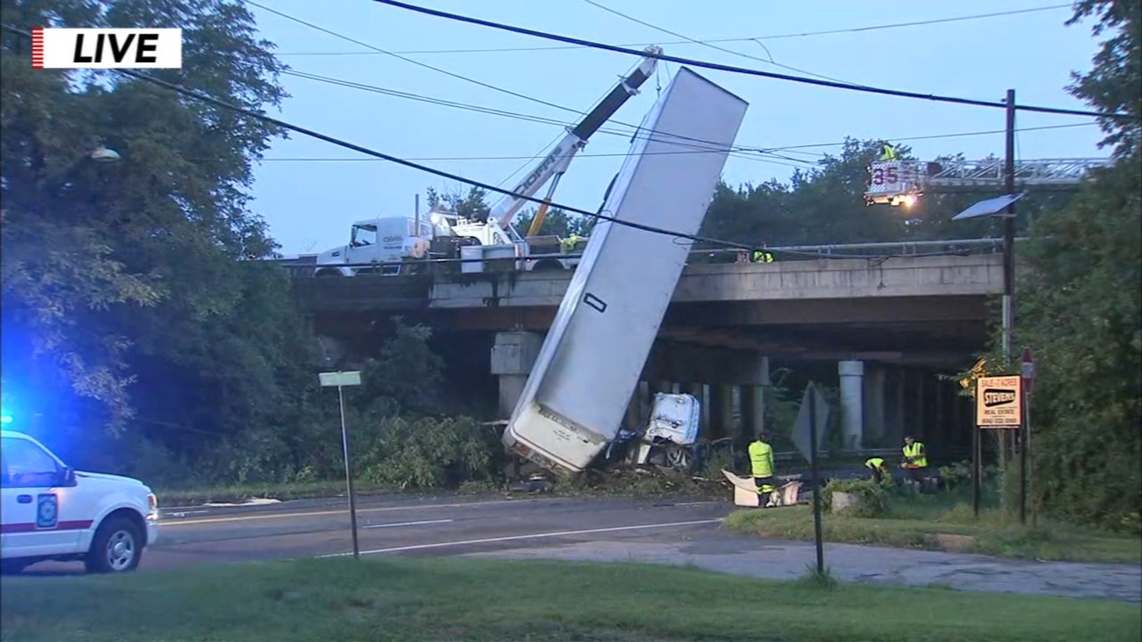 Crews move tractor trailer hanging over edge of I295 overpass in Mount