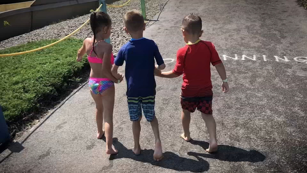 Friends help boy with cerebral palsy walk