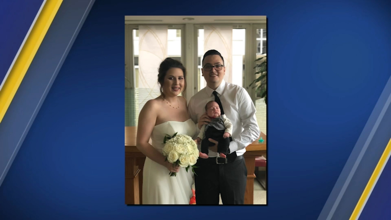 Bride walks down the aisle holding preemie baby
