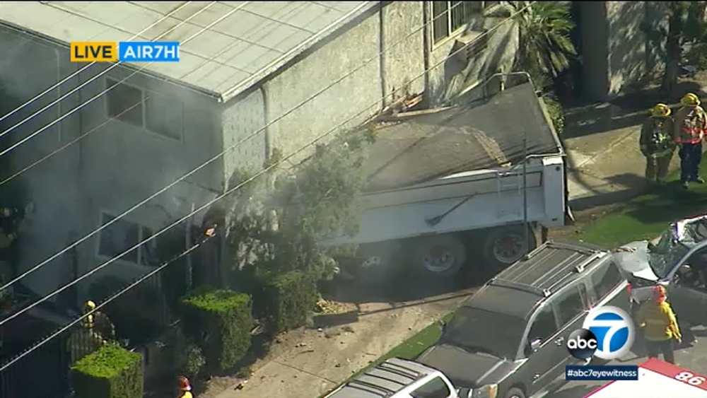 Dump truck crashes through apartment building in Pacoima