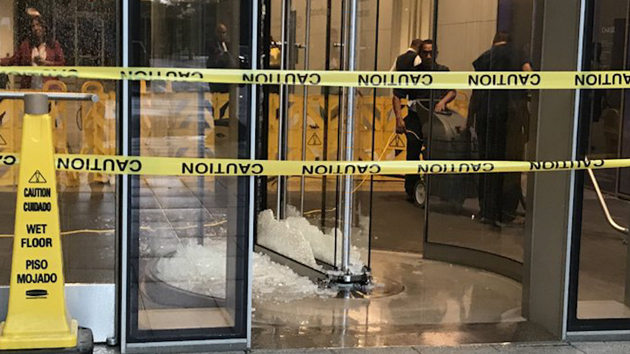 High wind shatters revolving door of building downtown
