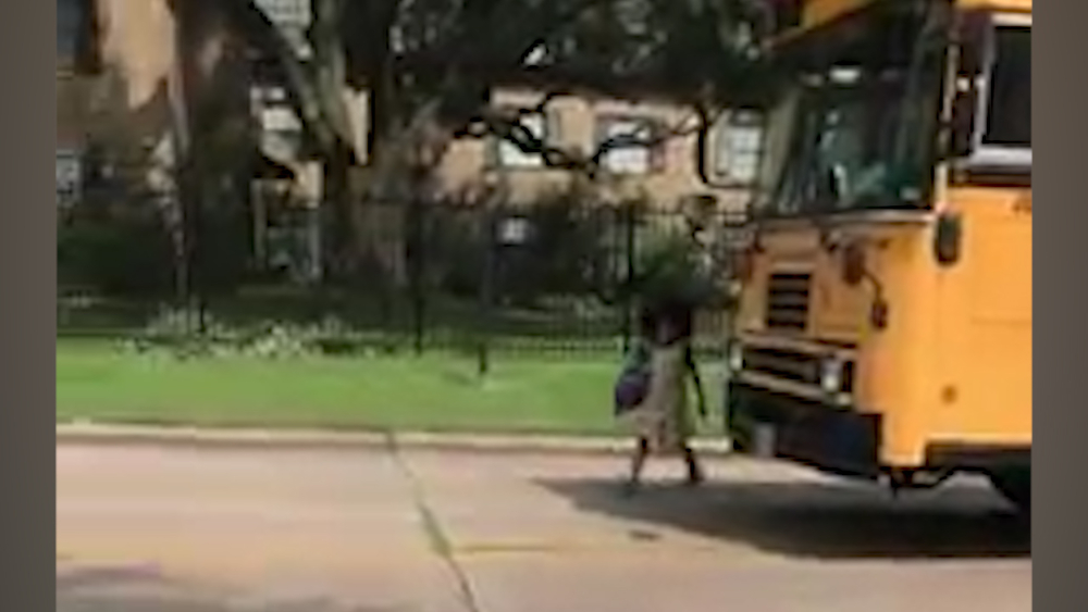 Chlld almost hit by car, driving past bus