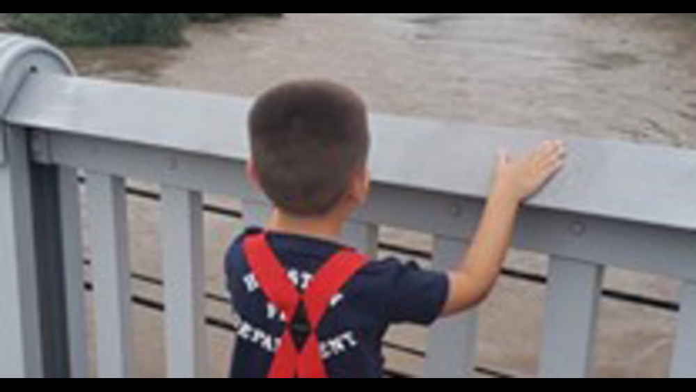5-year-old overlooks Buffalo Bayou during Imelda