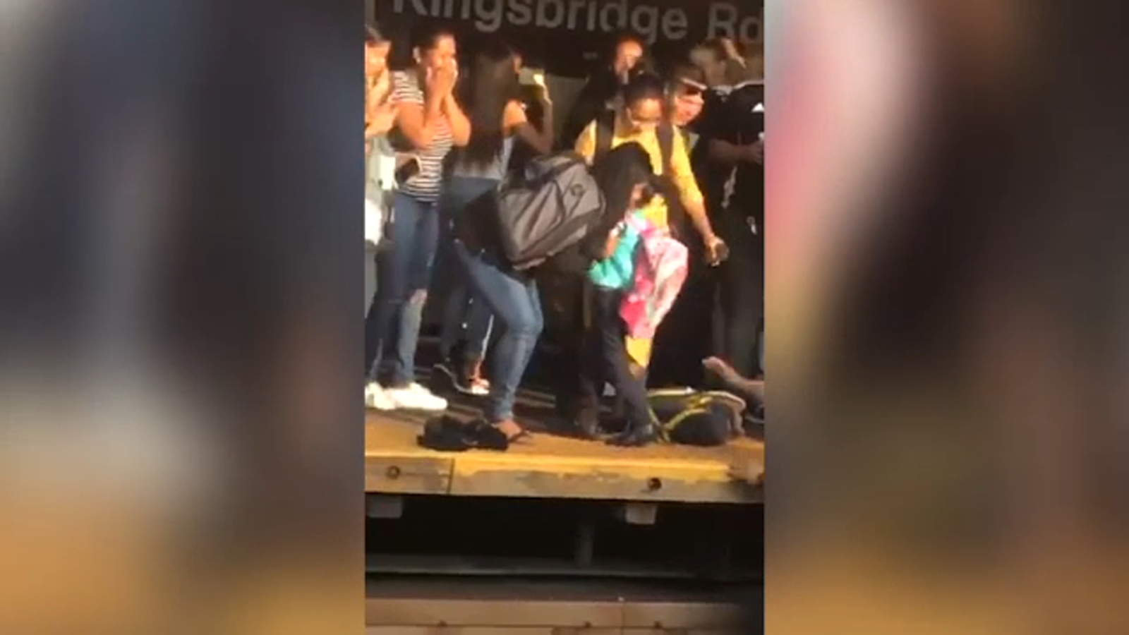 Commuters save girl after dad jumps with her in front of subway train