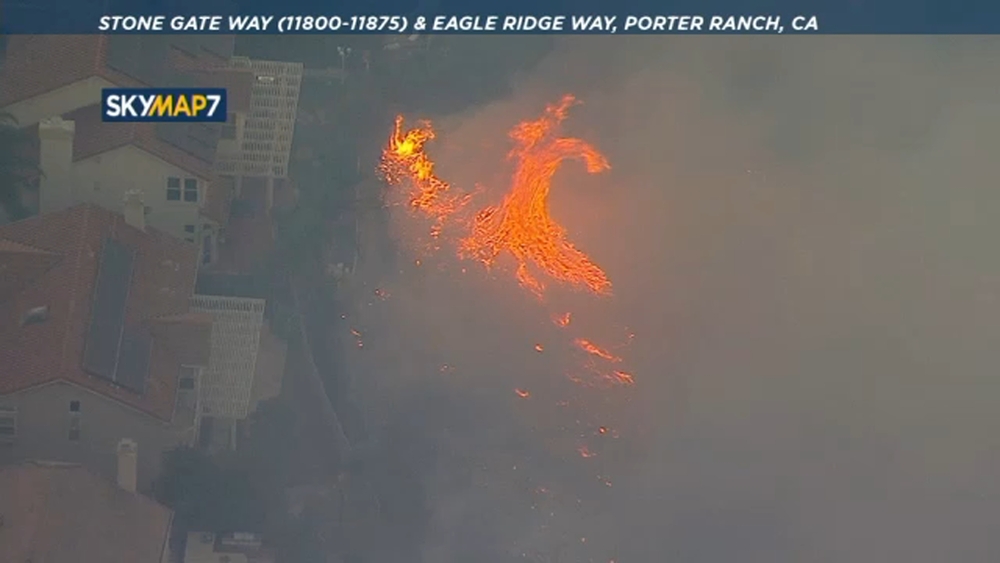 Massive flames lap up against Porter Ranch homes