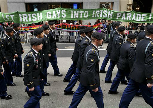 Marchers walk past a group of protesters during the St. Patrick's Day Parade  The group was protesting the exclusion of LGBT groups from the parade. (AP Photo/Seth Wenig)