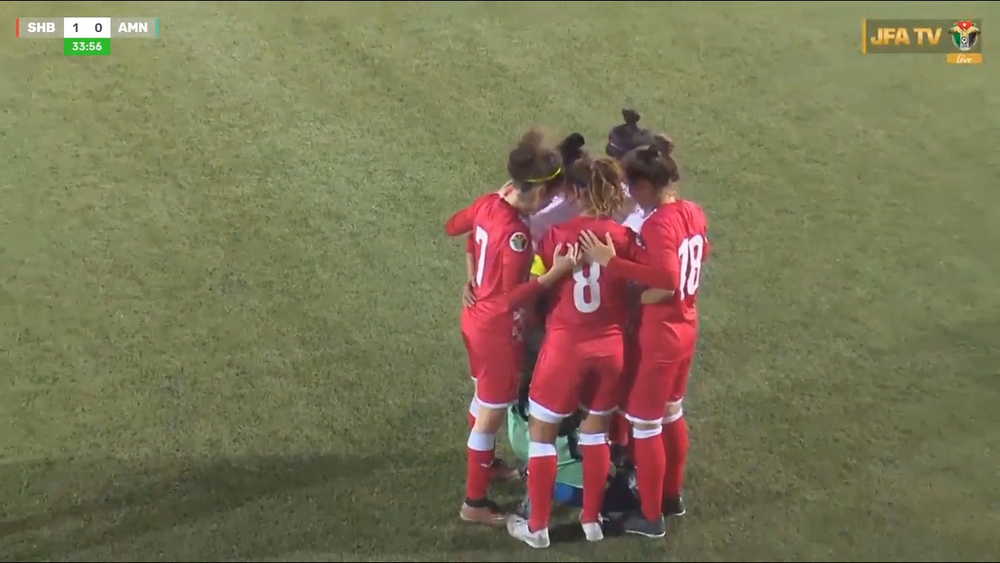 Opponents huddle around soccer player after hijab comes loose during match