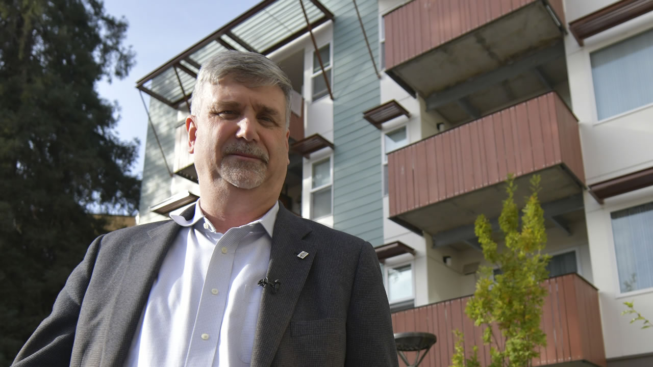 Louis Chicoine poses in front of one of the properties he helped develop in Fremont, Calif.