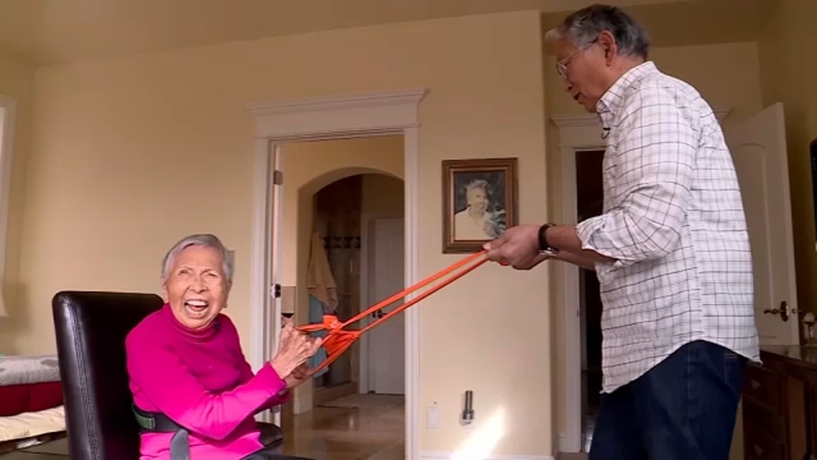 Elderly woman exercising with her 75-year-old son