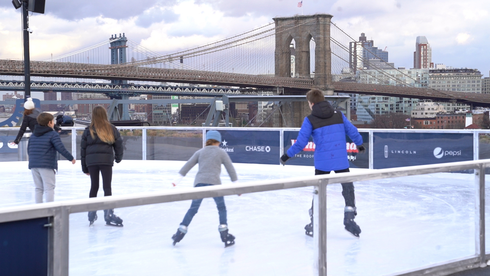 Ice skate on a rooftop with skyline views of NYC