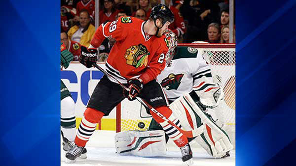 Chicago Blackhawks' Bryan Bickell (29) scores against Minnesota Wild goalie Ilya Bryzgalov (30) during the second period in Game 5.